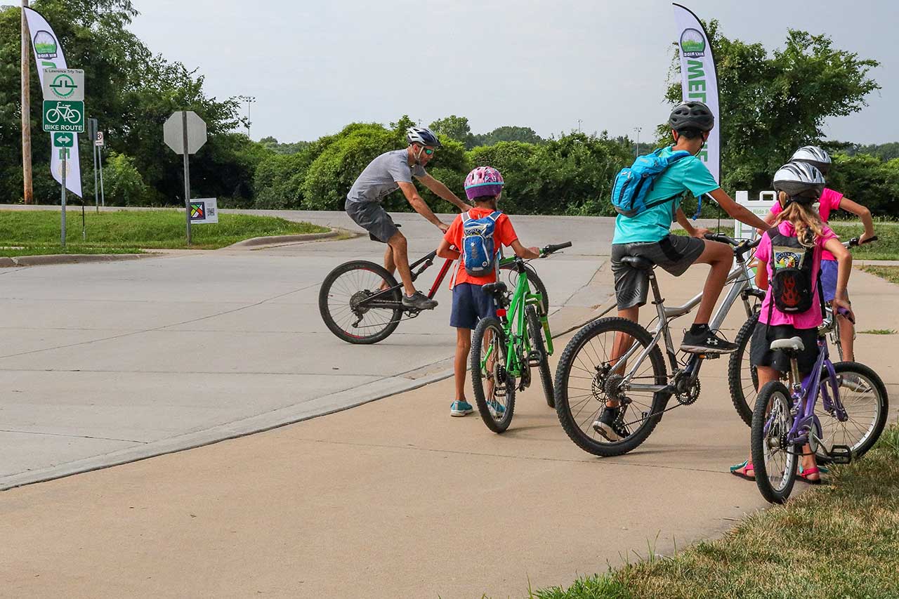 A dad and kids getting ready to ridw