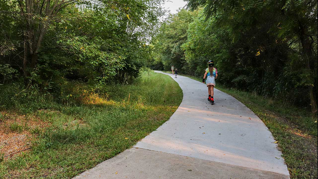 Kids riding razors on the trail