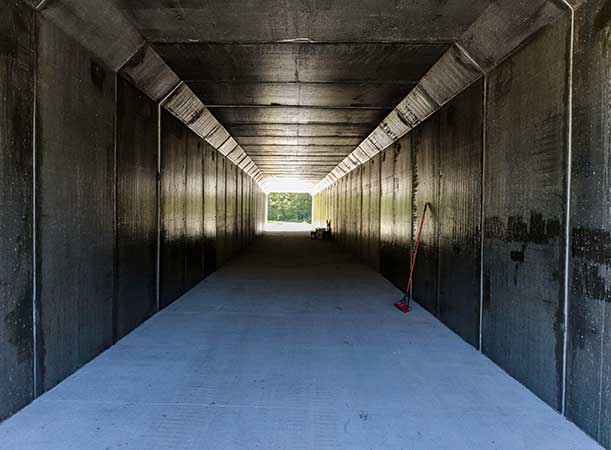 Lawrence loop tunnel with a broom propped against the wall