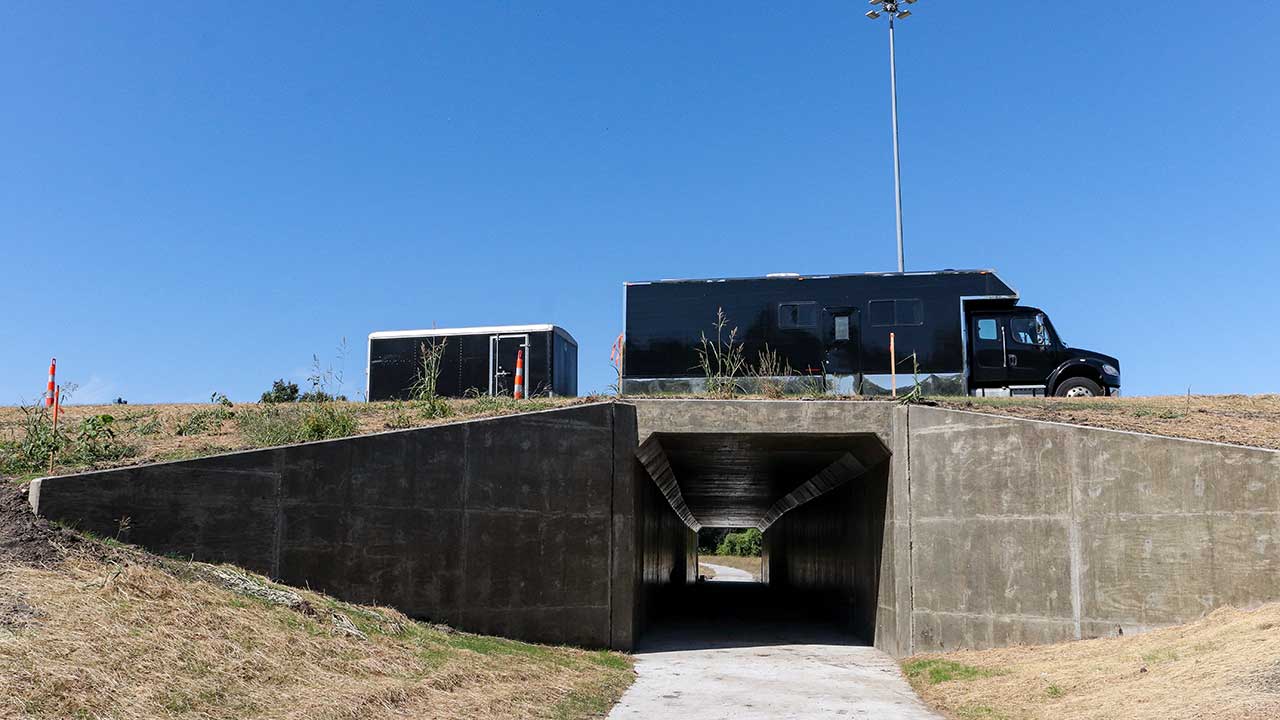 A vehicle goes over the tunnel