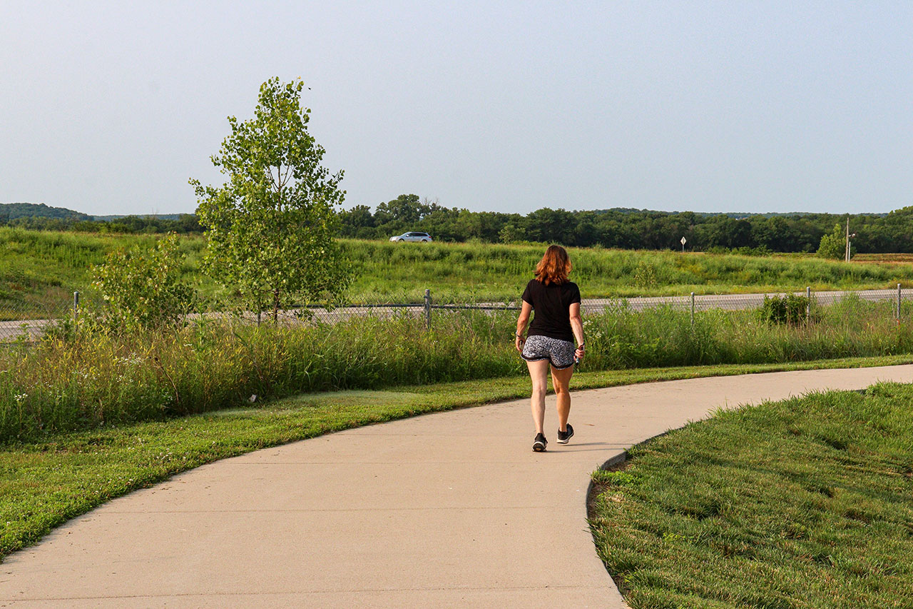 A woman walking on the Loop by the Nest Townhomes