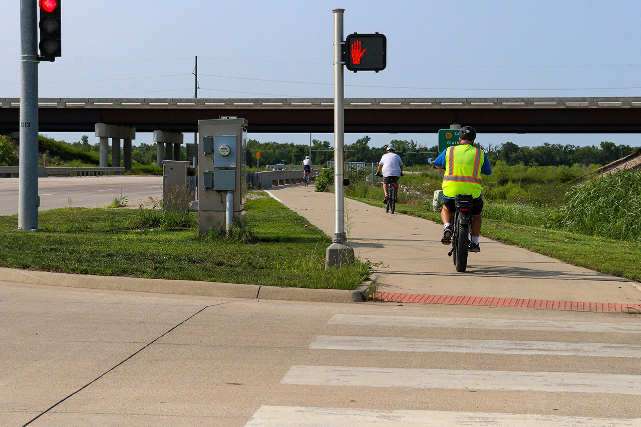 People biking on the trail past the 31st St intersection