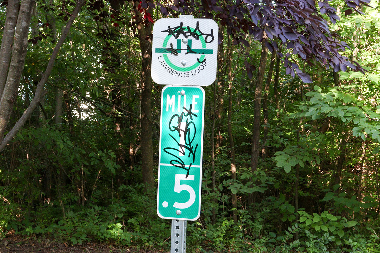 The Lawrence Loop Mile Marker 1.5, located on the trail south of 15th Street