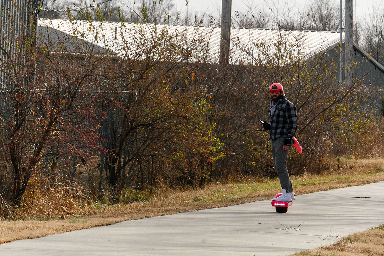 A man on a hover board on the trail