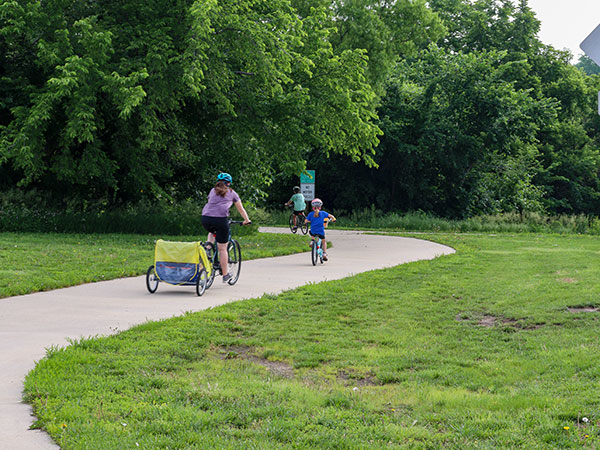 A woman and her kids biking on the loop
