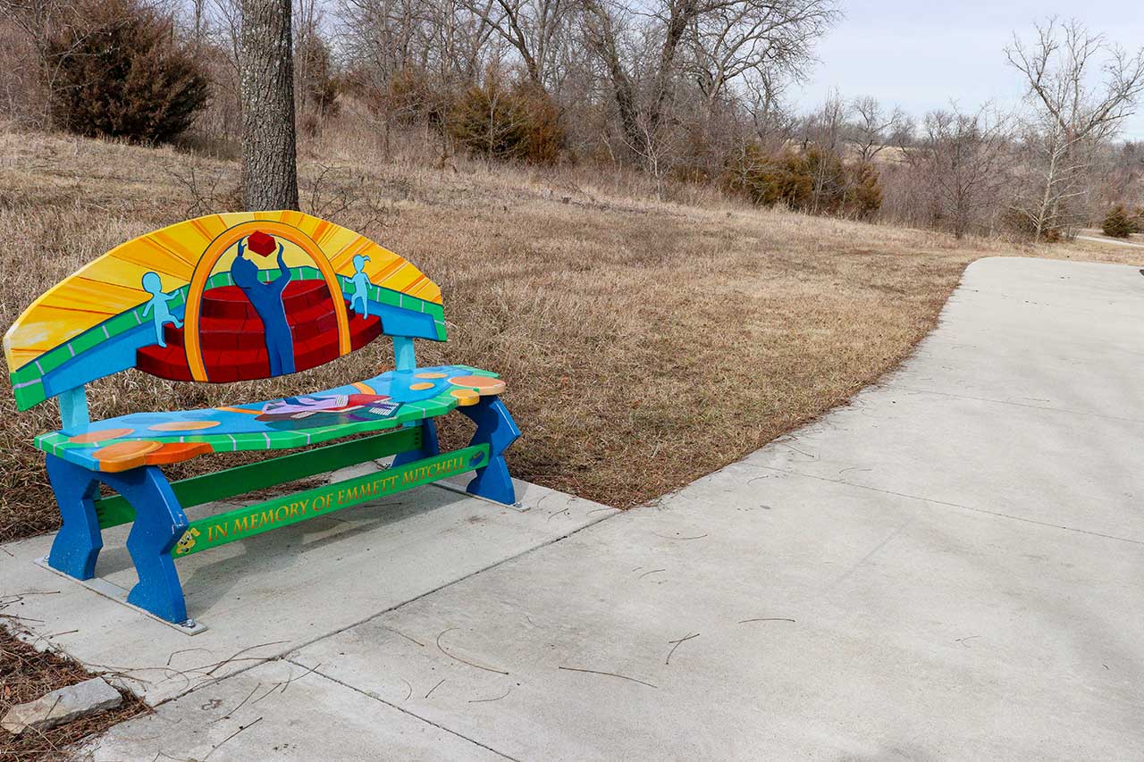 A brightly painted bench near the start of the trail
