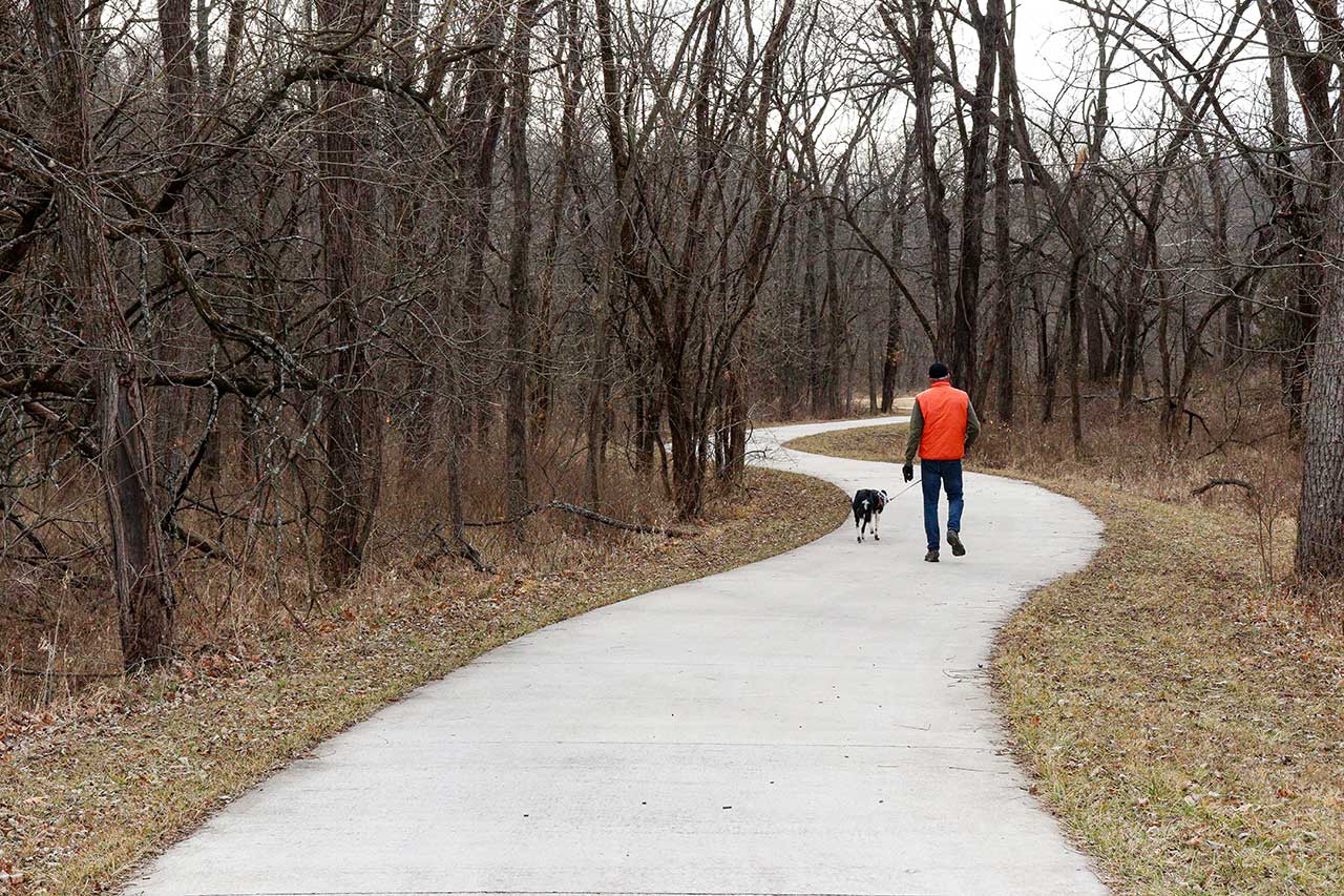 A man walking his dog on the Baldwin Creek Trail
