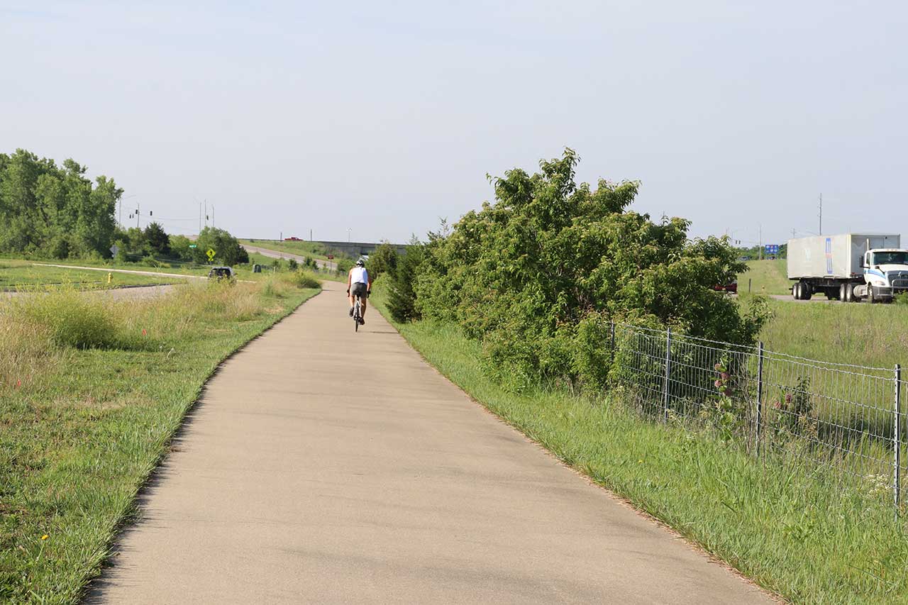 A man riding his bike near the end of segment 6 of the loop