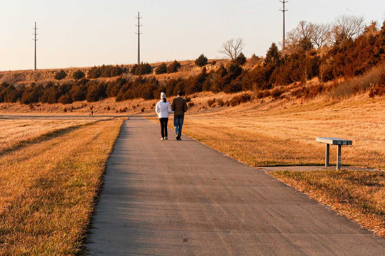 A couple walking on the loop west of the arboretum