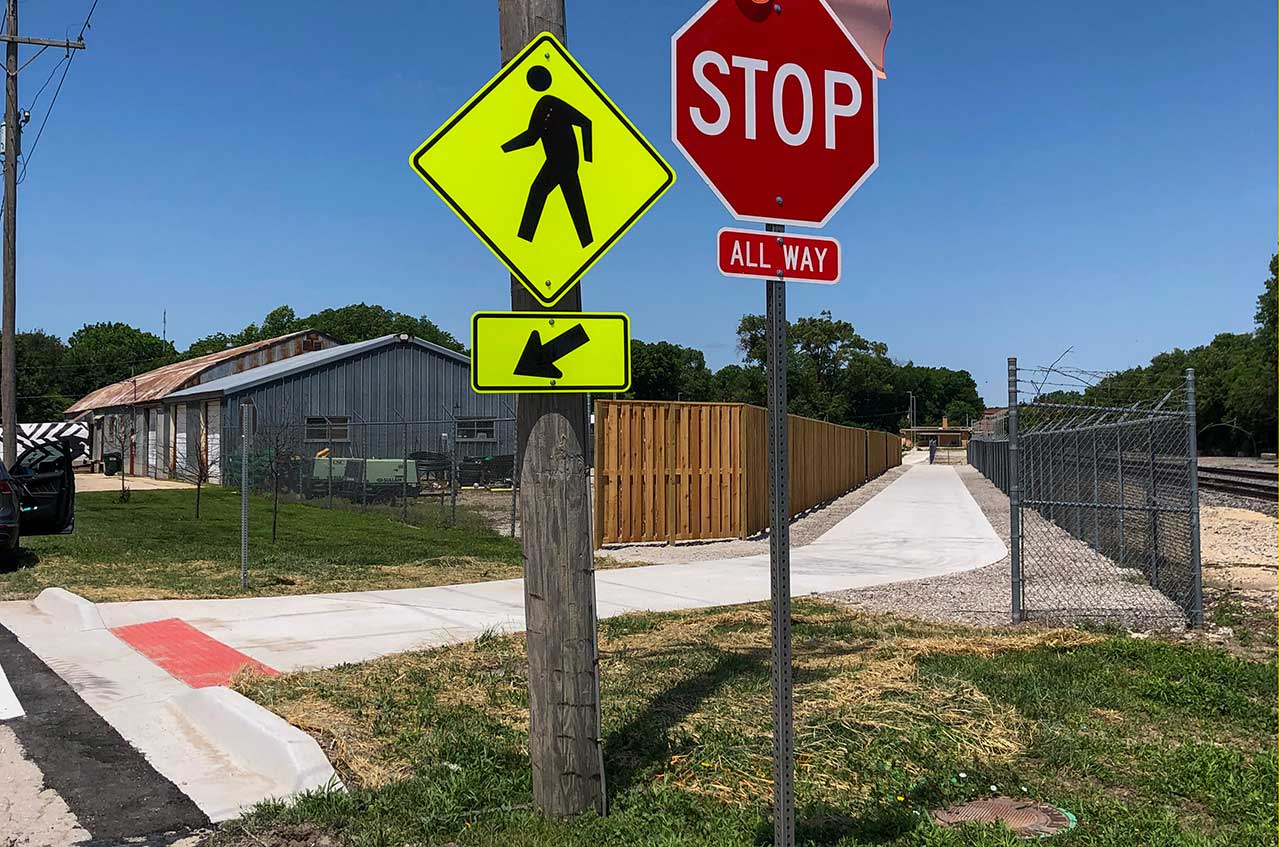 A pedestrian crossing sign along the new segment at 8th and Delaware Streets