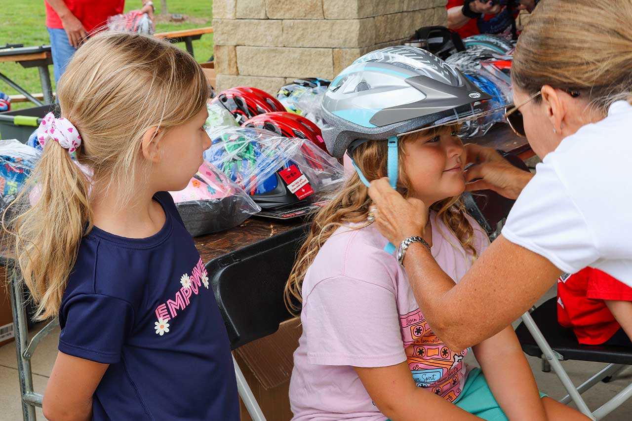 A person getting fitted for a new bike helmet