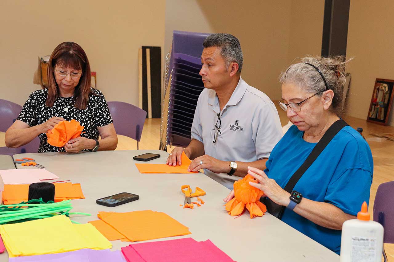 Family members gathered to create paper flowers for the exhibit