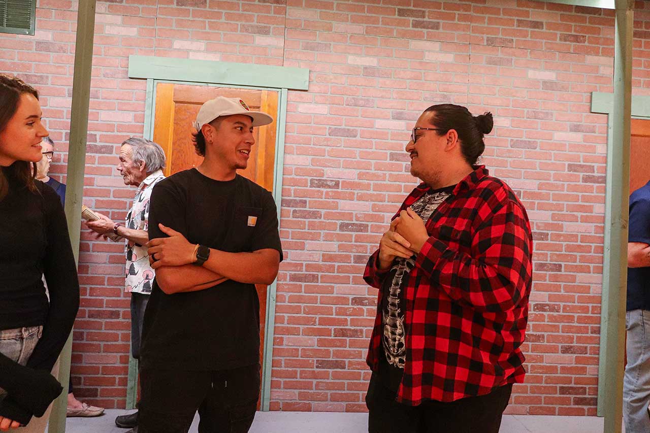 Loop artist Javy Ortiz talking with visiting artists Justin Favela at the exhibit opening