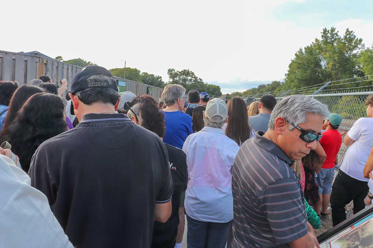 The crowd watching the ribbon cutting