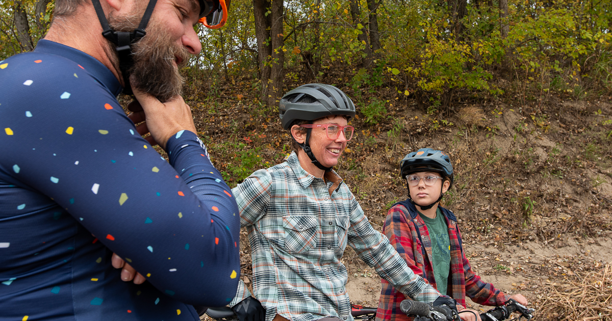 People on bikes talking on a trail