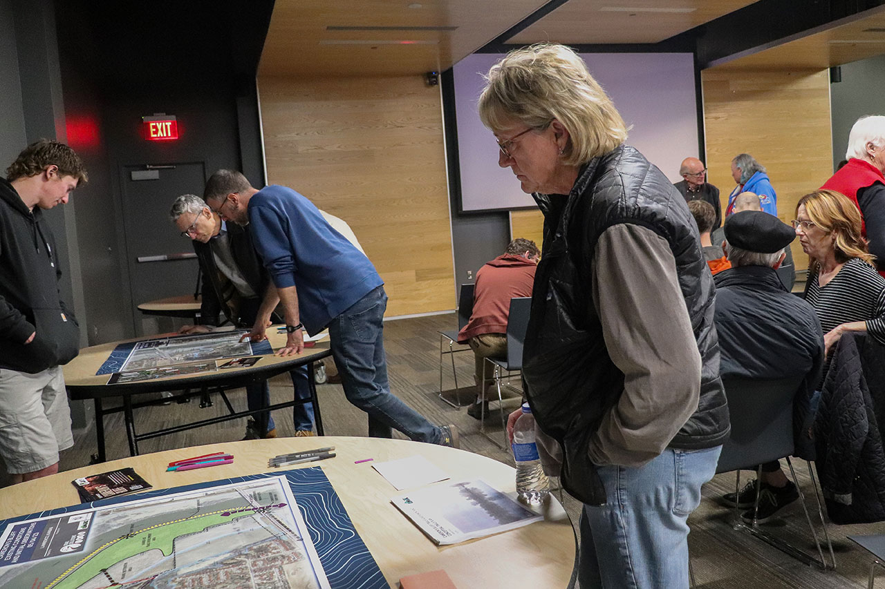 people looking at the tables at the cameron's bluff open house