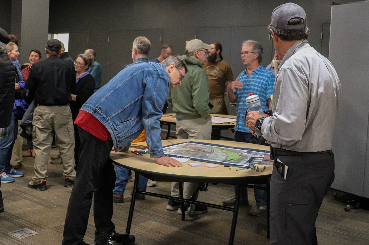 people looking at the tables at the cameron's bluff open house