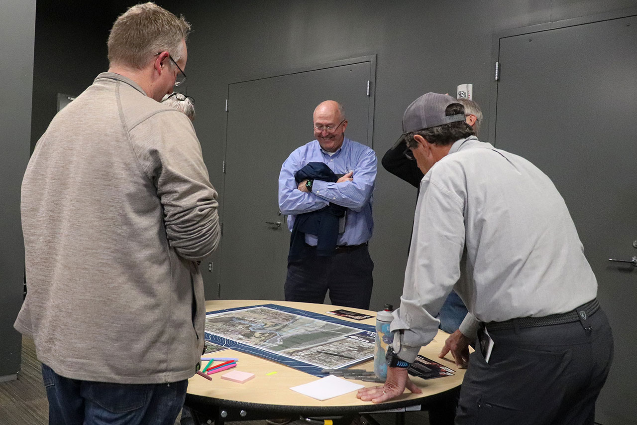 people looking at the tables at the cameron's bluff open house