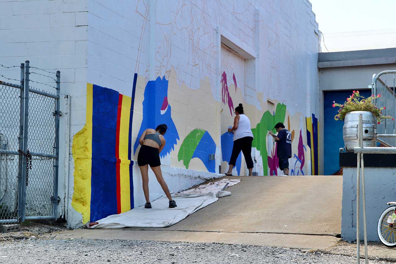People painting the mural