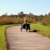 A person riding a recumbent bike on the Sanders Mound Trail