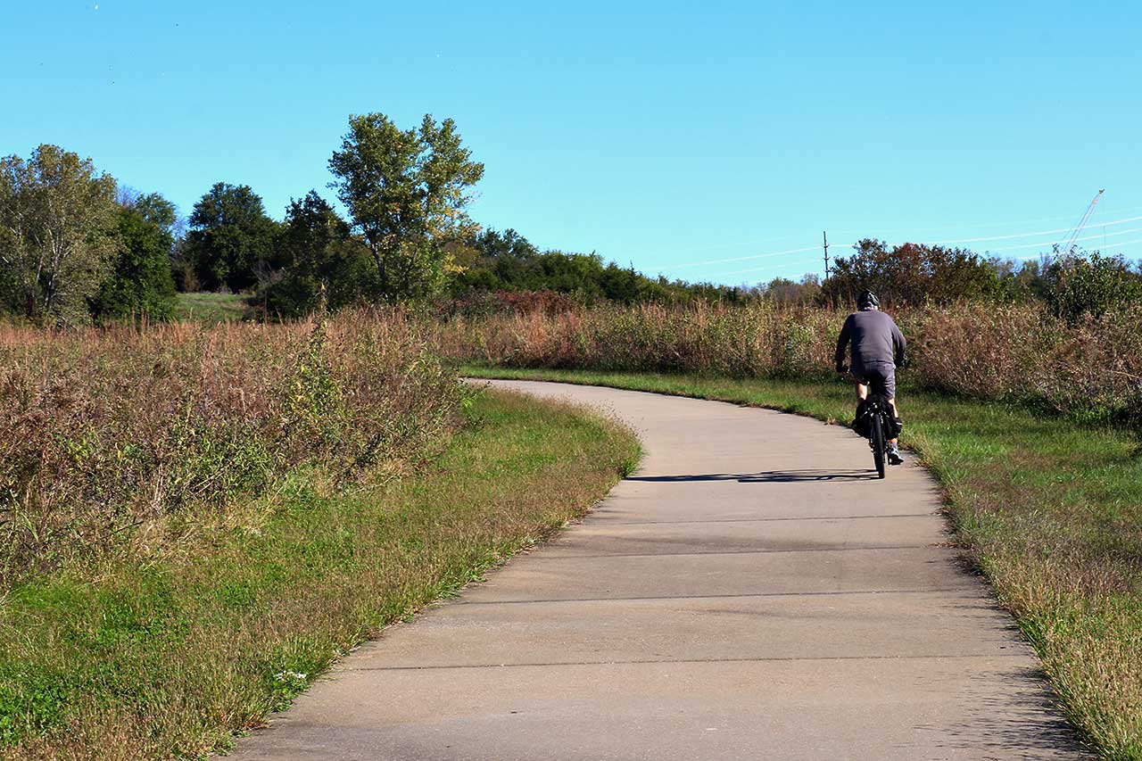 A person riding a bike on the trail